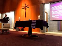 altar with candles, cross on wall, and student