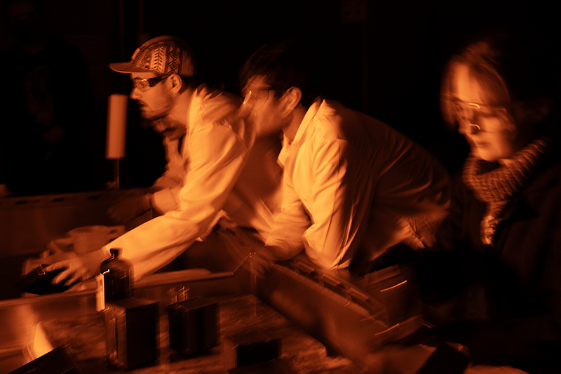 Students work in a darkroom.