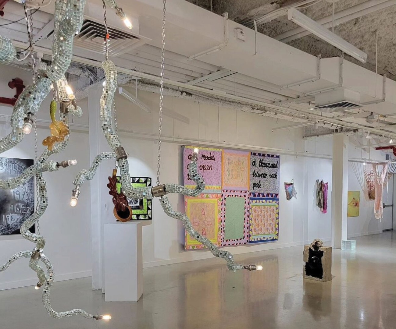 A gallery with installation pieces hanging.