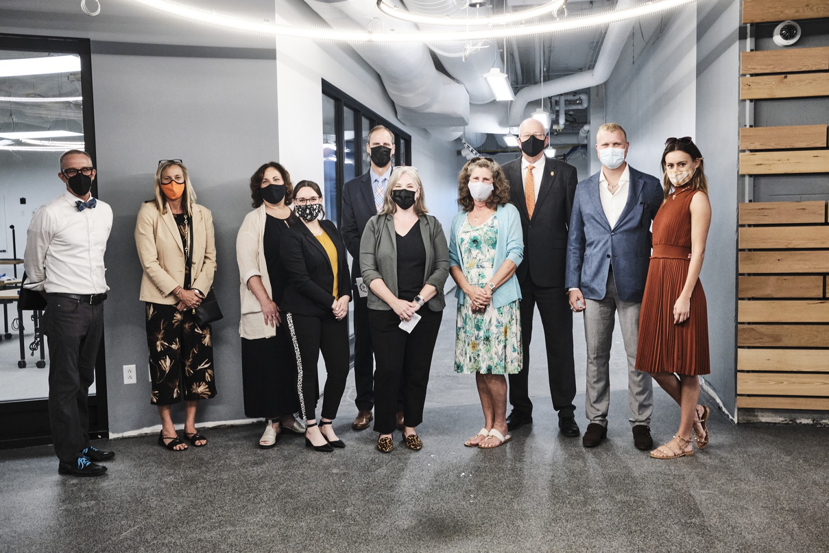 A group of people standing in RIT's newly renovated photo space. 