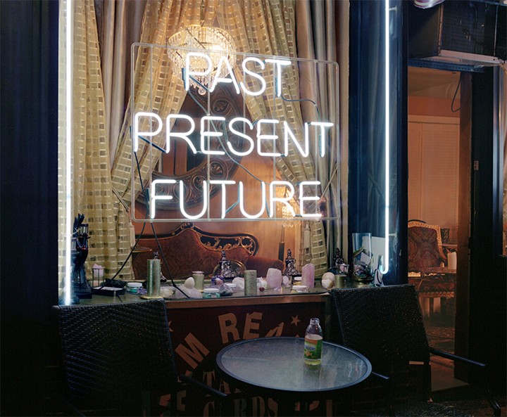 Neon-like writing in a window that reads Past Present Future.