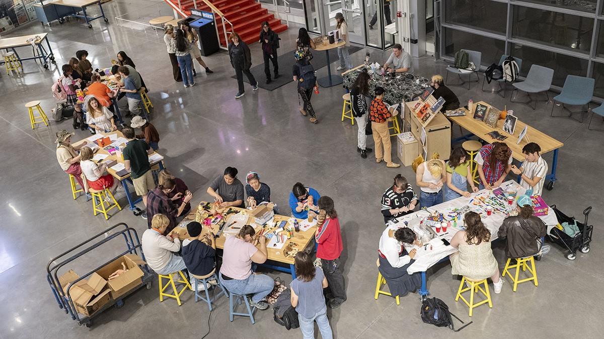 An overhead view of students making Halloween-themed creative projects.
