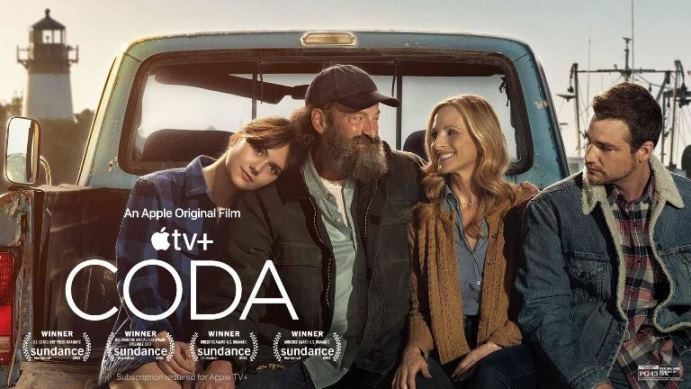 Picture is 4 actors sitting on the back of a pick up truck with the movie title CODA written across it