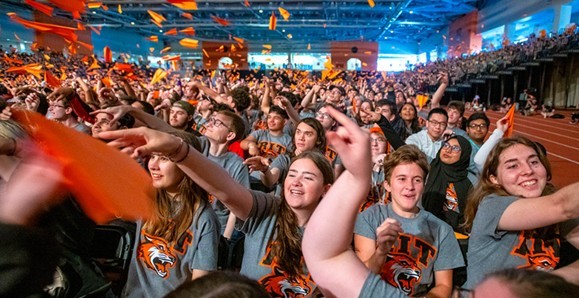Students sitting in audience smiling