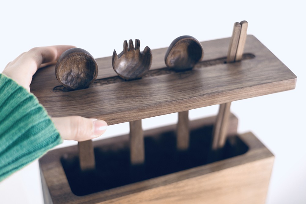 A rack holds four kitchen utensils.