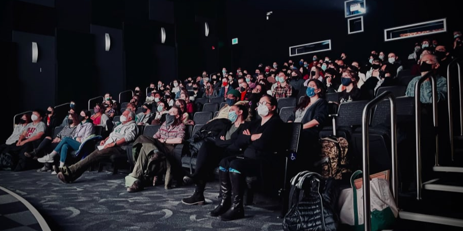 image of an audience looking at a screen
