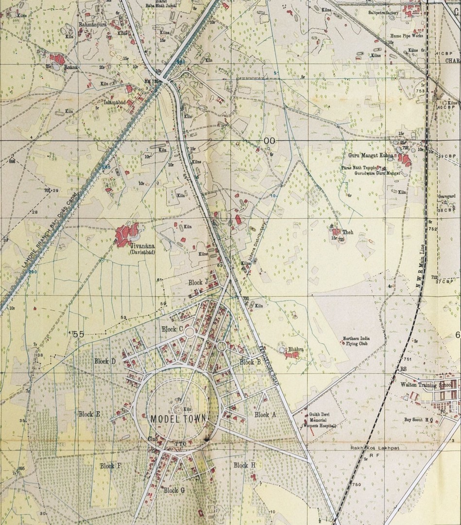A vintage topographic map showing Model Town and surrounding areas. Model Town is laid out in a circular plan at the center, divided into labeled blocks (A through H) with radial roads and roundabouts. Surrounding areas include villages, agricultural land, scattered buildings, canals, rail lines, and roads. Notable labels include Jivanna (Davisabad), Guru Mangat, Walton Training School, Northern India Flying Club, and various kilns. The map uses light earth tones, grid lines, and symbols to indicate terrain