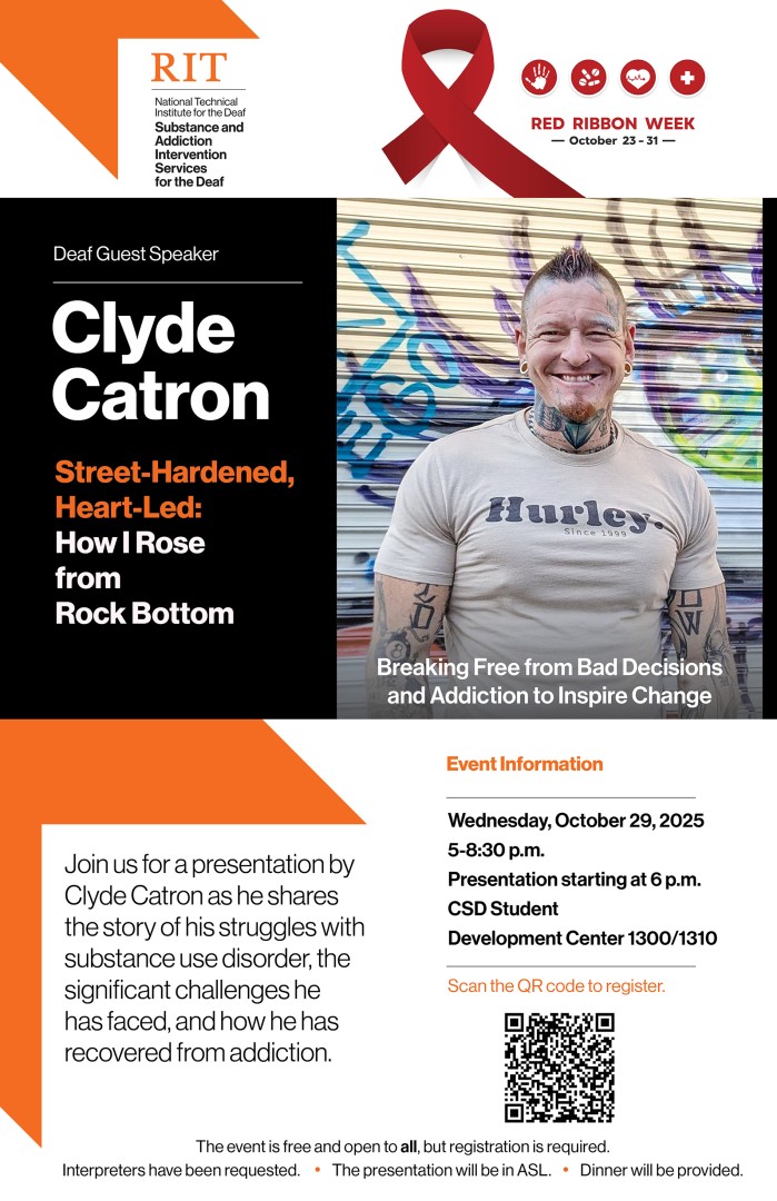 image of Clyde Catron smiling and wearing a t-shirt, has a spiked haircut and many tattoos.