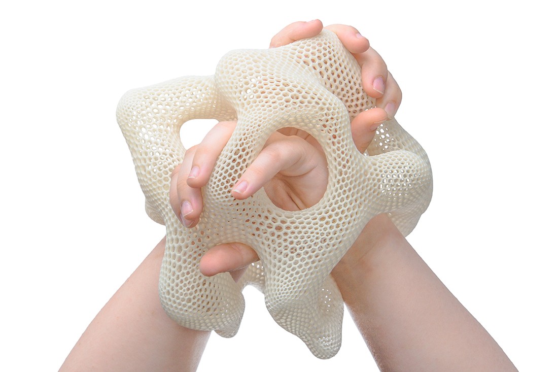 A 3D wearable object sitting on someone's wrists.