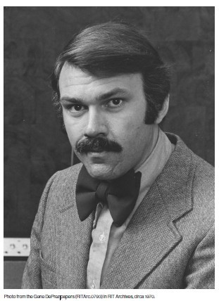 Black-and-white studio portrait of a man with dark hair and a thick mustache, wearing a bow tie, collared shirt, and textured jacket, looking directly at the camera against a plain backdrop.