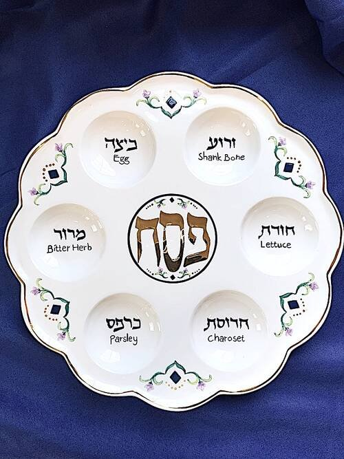 Jewish Passover seder plate on blue background