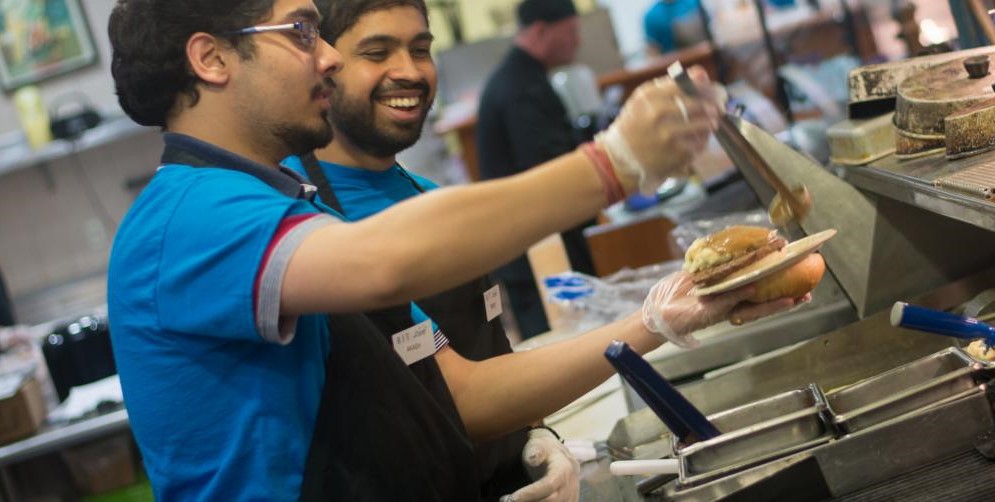 Someone serving food in Dining 