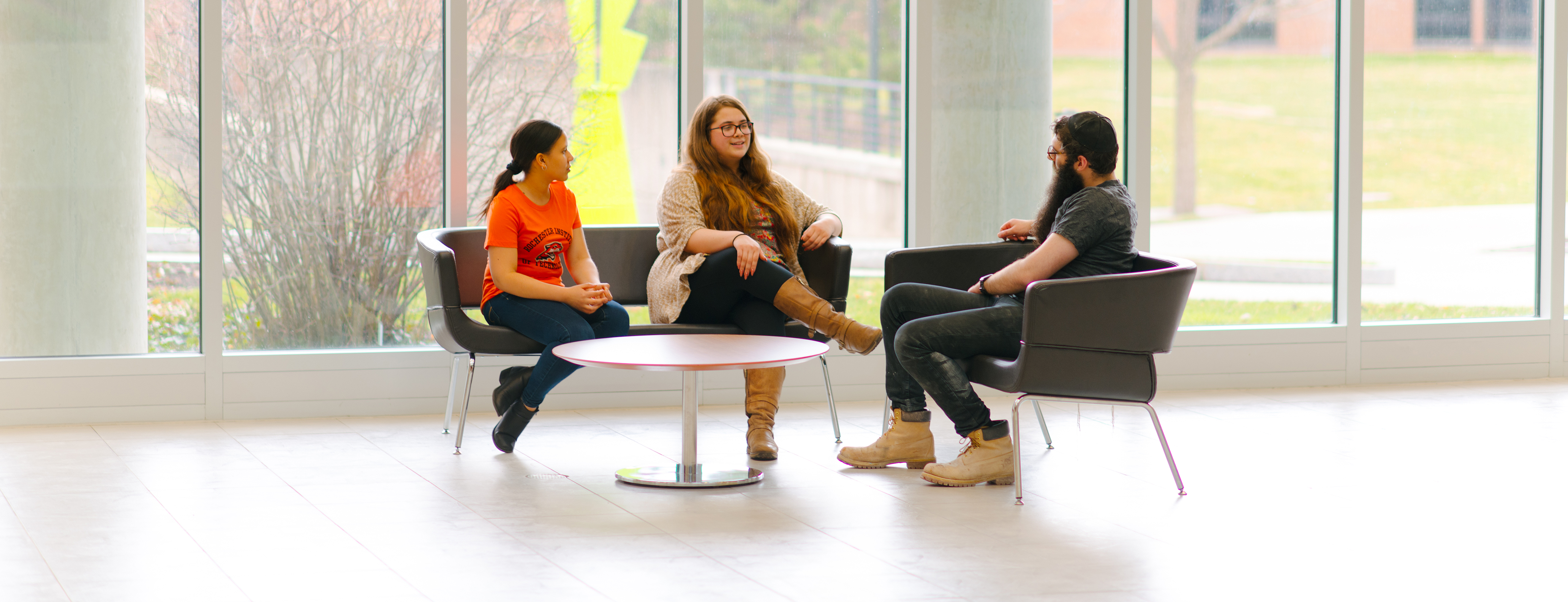 Three students sitting and talking.