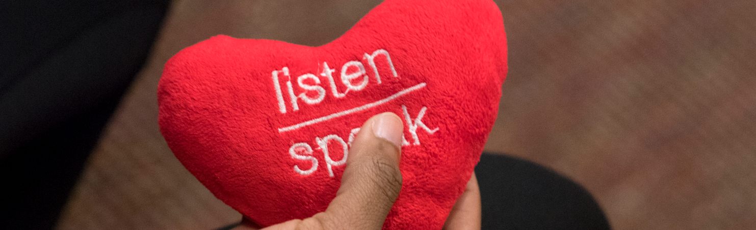 red plush heart with the words listen speak