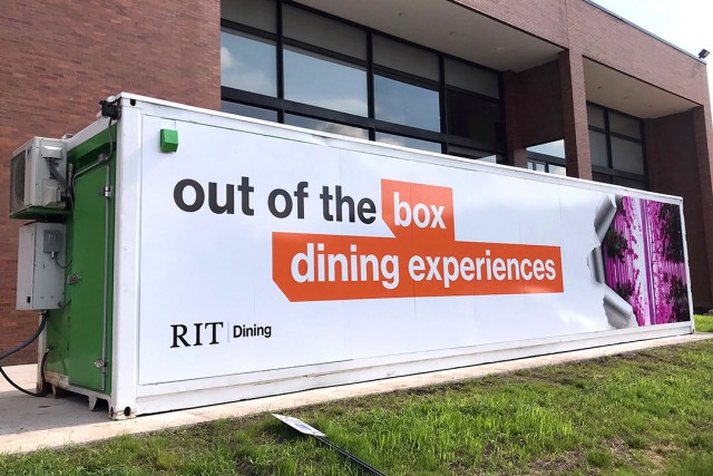 Shipping container converted into greenhouse that reads: Out of the box dining experiences.