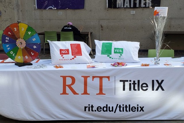 table with games, giveaways, and a banner that reads RIT Title nine.