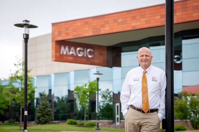 James Moore is shown standing in front of MAGIC Spell Studios.