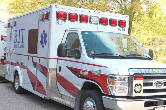 the front of an ambulance is shown parked on the R I T campus.