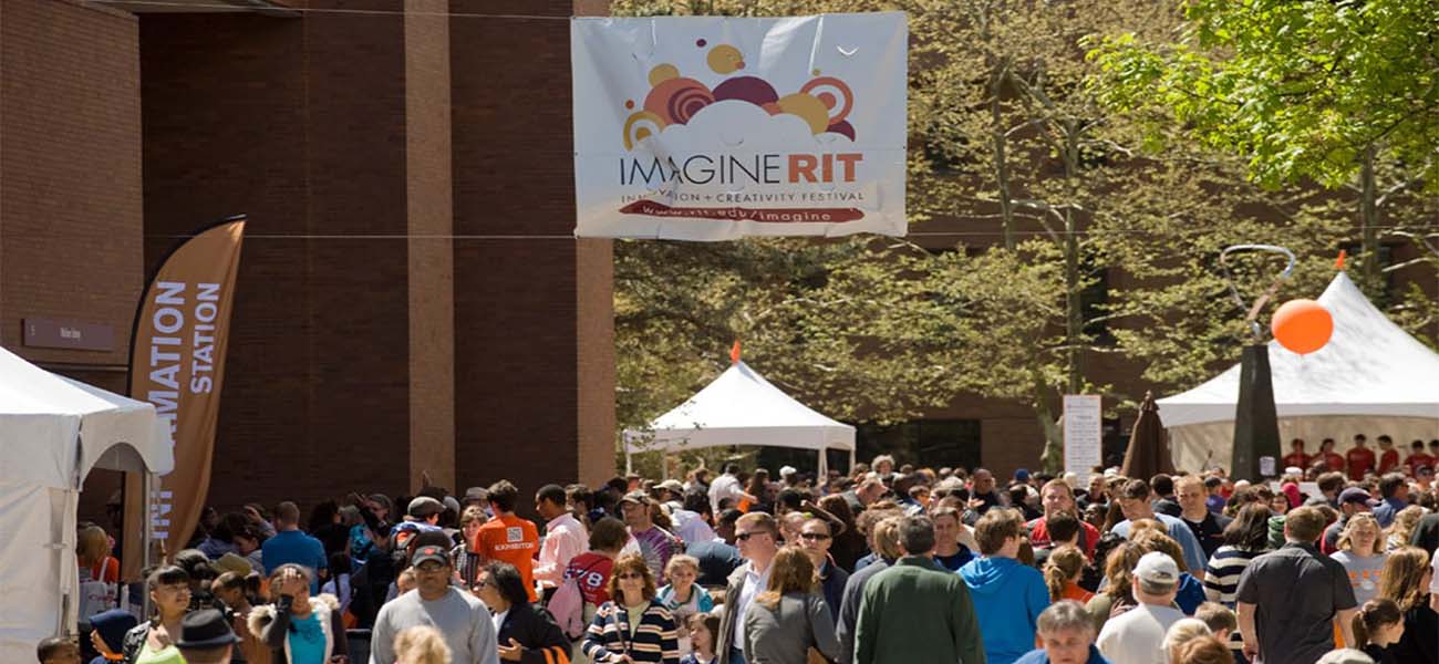 A crowd of people walking the Quarter Mile during Imagine RIT