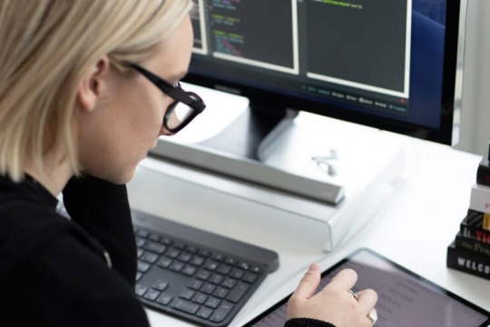 Woman looks at iPad.