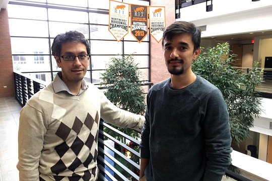 two men standing in lobby of computing hall.