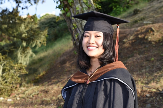 student wearing graduation cap and gown.