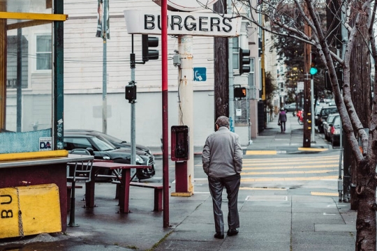 man walking down street alone.