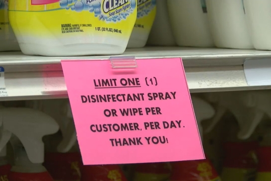 sign on grocery store shelf that reads: Limit one disinfectant spray or wipe per customer, per day.
