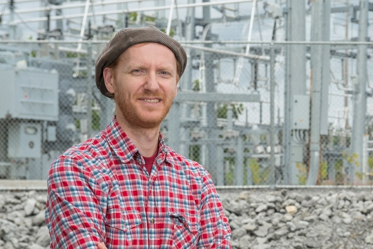 professor standing in front of power station.