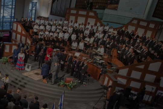 A choir and several people standing at the front of a church.