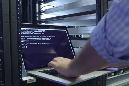 person on a laptio accessing a computer server system.
