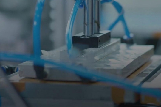 Machining tool with blue wires.