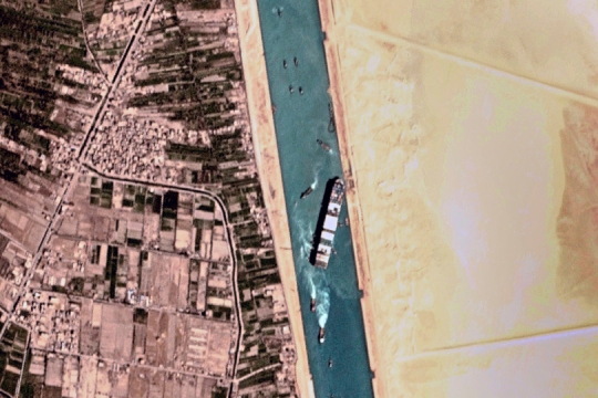 satellite view of a container ship stuck in a canal.