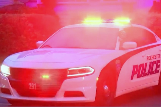 Rochester Police Department car with its lights on.