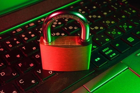 a padlock sitting on a computer keyboard.