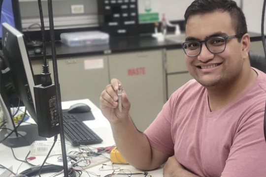 student working with photonics equipment.