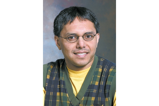 Man with glasses and yellow plaid shirt. 