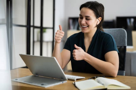 person giving a thumbs-up in a virtual meeting.