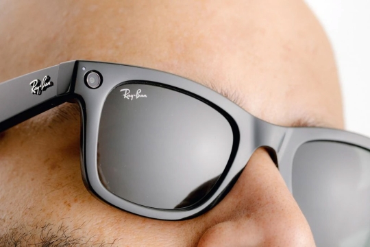 close-up of person wearing Ray-Ban sunglasses with a small camera in the frame.