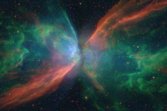image of the butterfly nebula in greens and reds.