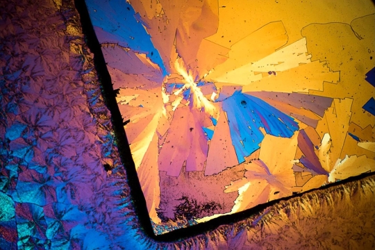 a photomicrograph of a medication with blue and yellow angular elements.
