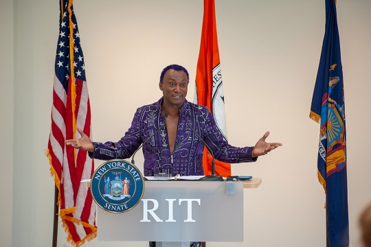 man speaking at podium.