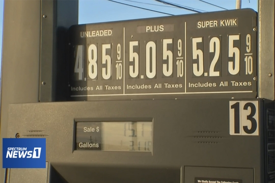 gas pump showing 4 dollars and 85 cents for a gallon of unleaded gas.