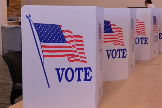 dividers with the American flag and the word Vote on a table.