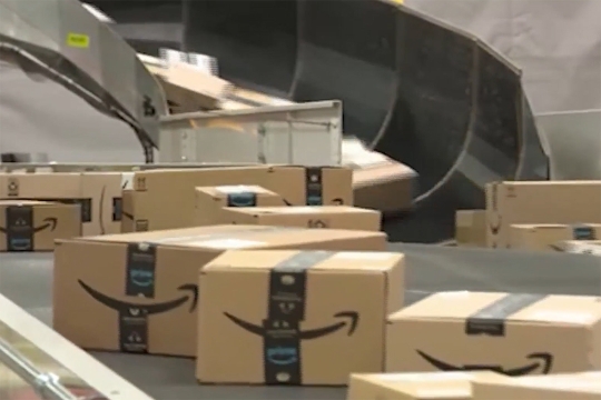 Amazon boxes on a conveyor belt.