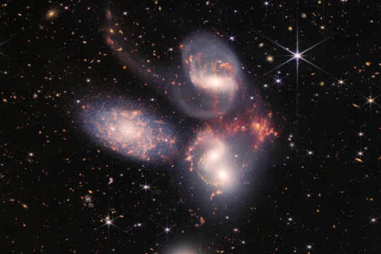 three galaxies in space.