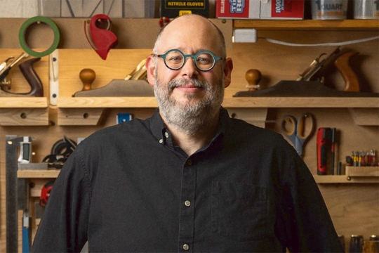 Portrait of Mitch Goldstein in front of work area.