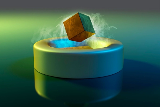 a cube levitating above a cylindrical disk.