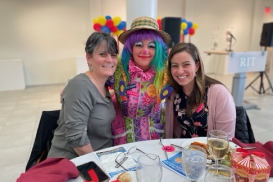 a photo of the interim dean with a clown and jennifer