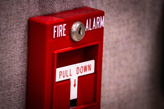 close up of a fire alarm pull box.